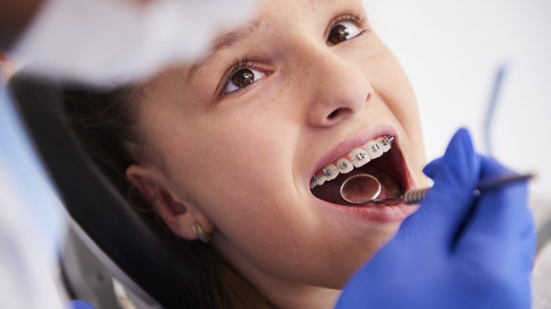 Girl with braces during a routine, dental examination